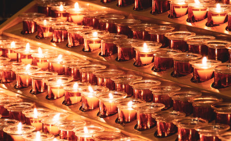 Candles lit inside a Catholic church for the deceased or for vows. Candles inside St. Patrick's Cathedral, New York, Manhattan, USA.の写真素材