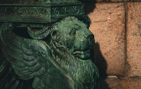 Bronze lion on a street lamp in Manhattan, New York, USA. Decorative detail of a street lamp in...