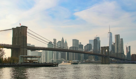 Manhattan and East River cityscape at dusk. Brooklyn Bridge and Jane's Carousel, and Manhattan from...