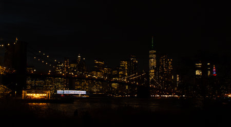 New York City skyline from Brooklyn on an autumn night. Brooklyn Bridge, Jane's Carousel, and...