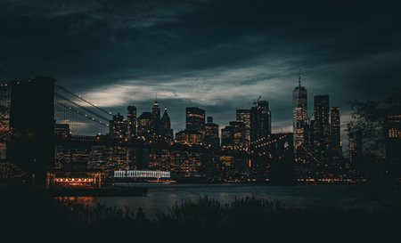 New York City skyline from Brooklyn at dusk in autumn. Brooklyn Bridge, Jane's Carousel, and Manhattan seen from the lawn of Main Street Park. NYC, USA. 2019.の写真素材