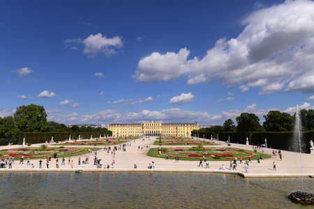 Classic view of famous Schonbrunn Palace with scenic Great Parterre garden on a beautiful sunny day with blue sky and clouds in summer, Vienna, Austriaのeditorial素材
