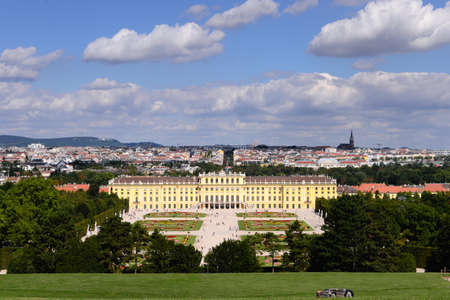 Classic view of famous Schonbrunn Palace with scenic Great Parterre garden on a beautiful sunny day with blue sky and clouds in summer, Vienna, Austriaのeditorial素材