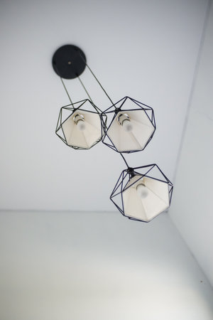 Hanging light bulbs and lamps in the style of a modern coffee shop as interiors in the houseの写真素材
