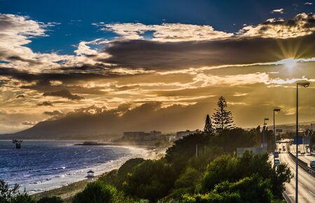 spring landscape in marbella with a beautiful sunset in which we see the beach and marbella in the backgroundの写真素材