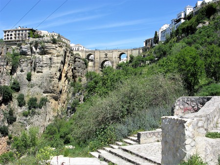 Arched bridge across the gorge and buildings at Ronda, Andalucia, Spainの写真素材