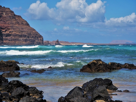 Blue Atlantic waves approaching the volcanic coast near Orzola, Lanzarote