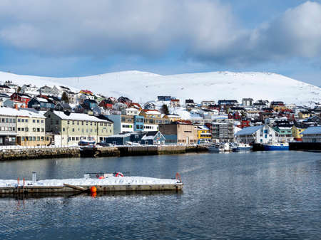 Honningsvag, Norway, in winter with snowcapped mountainsの写真素材