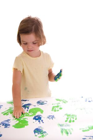 Little girl hand painting with green blueの写真素材