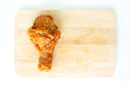 fried chicken drumstick on wooden backgroundの写真素材