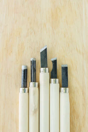chisel carving set on wooden backgroundの写真素材