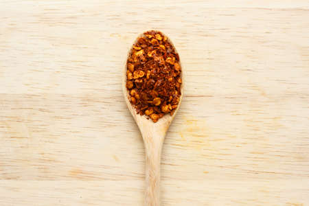 cayenne pepper spoon on wooden backgroundの写真素材