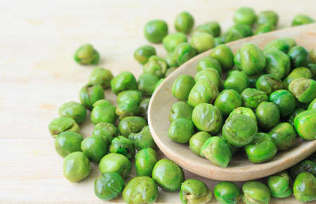 green peas on plate and woodenの写真素材