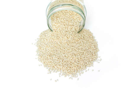 white sesame seed in jar on white backgroundの写真素材