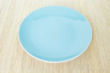 blue plate empty on bamboo mat background