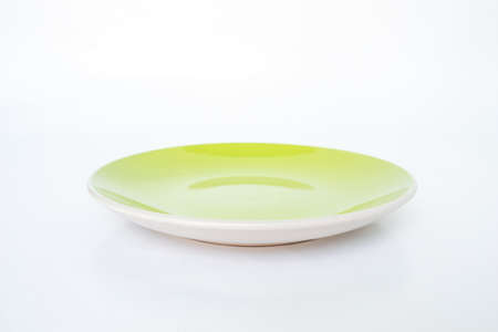green plate empty on white backgroundの写真素材