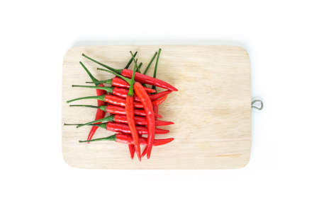 chili pepper red spicy vegetable cutting board on wood backgroundの写真素材