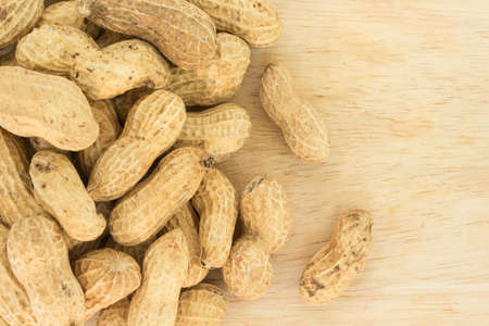 peanut in shell on wood backgroundの写真素材