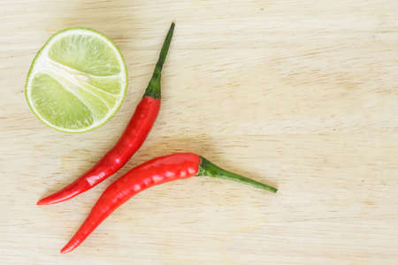 chili pepper red spicy and lime vegetable on wood backgroundの写真素材