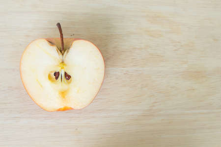 half red apple on wood backgroundの写真素材