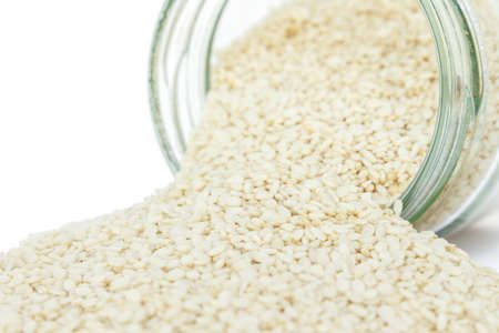white sesame seed in jar on white backgroundの写真素材