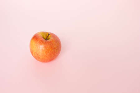 red apple on pink background