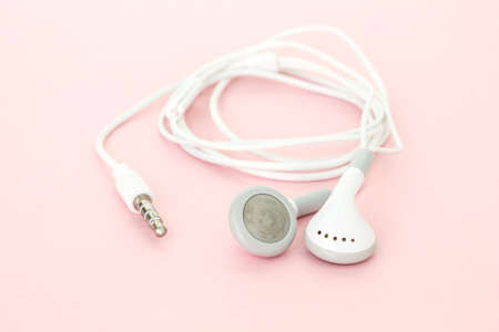 earbuds or earphones on pink background