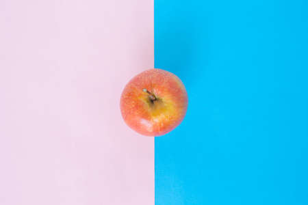 red apple on pink blue rose quartz serenity backgroundの写真素材