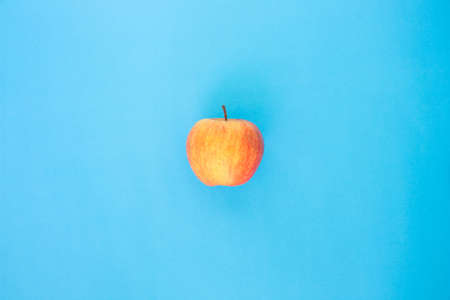 red apple top focus on blue backgroundの写真素材