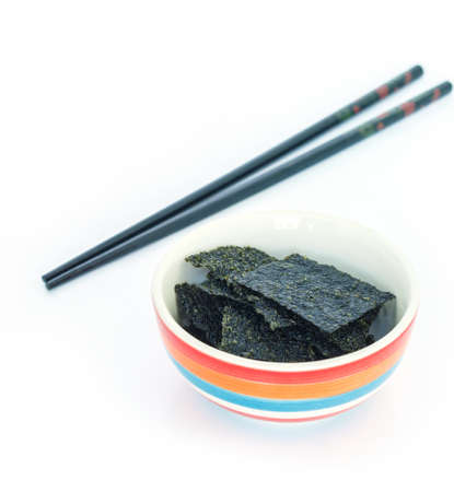 seaweed in bowl sea food chopsticks on white backgroundの写真素材