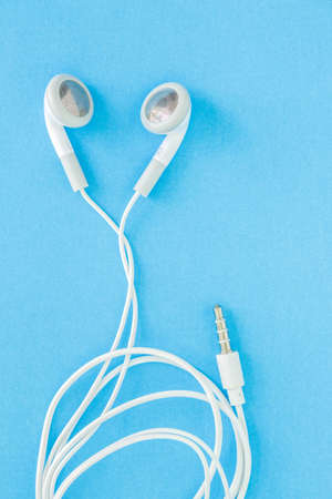 earbuds or earphones on blue backgroundの写真素材