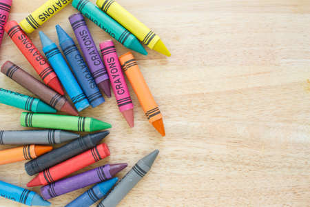 crayons drawing border multicolored on wooden backgroundの写真素材