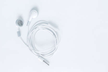 earbuds or earphones top view on white backgroundの写真素材