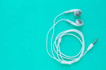 earbuds or earphones on green backgroundの写真素材