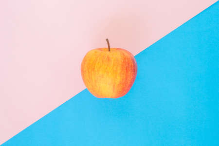 red apple on pink blue rose quartz serenity backgroundの写真素材