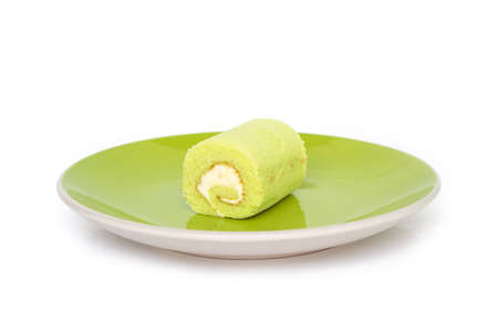 green cake roll on plate on white background.の写真素材