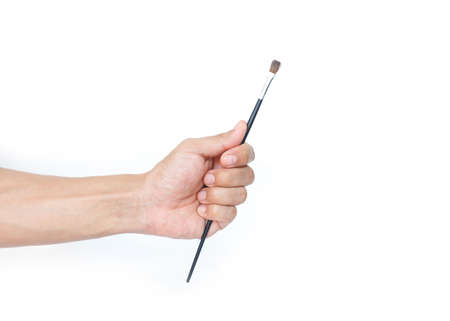 hand holding a paintbrush on white background.の写真素材