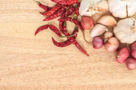 ingredients garlic, onion, chili food on wooden backgroundの写真素材
