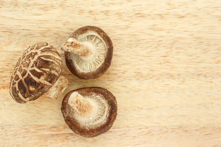 mushrooms top view on wooden background.の写真素材