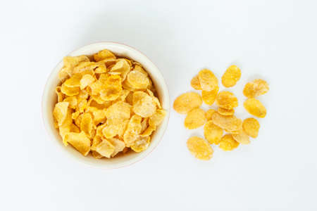 corn flakes on white bowl on white background.