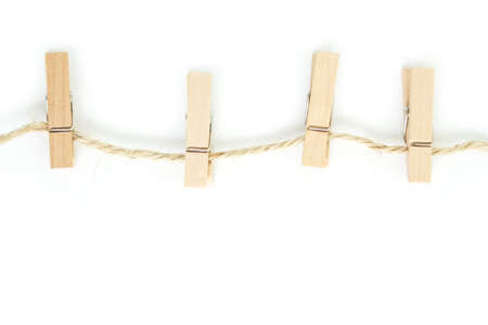 clothes pin and brown rope on white background.の写真素材