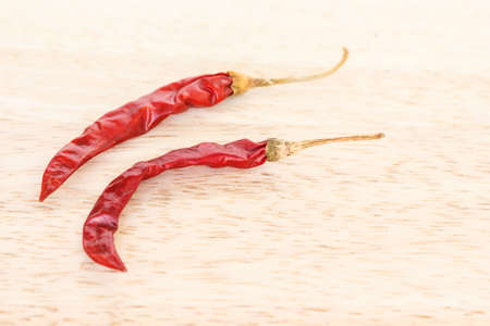 dried red chilli pepper on wood backgroundの写真素材