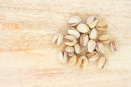 heap pistachio on wooden background.の写真素材