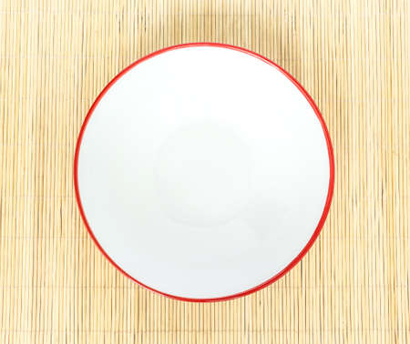 Red bowl top view isolated on wooden mat backgroundの写真素材