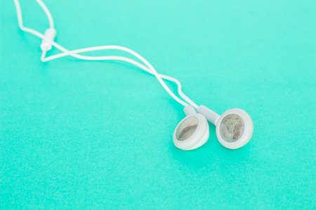 earbuds or earphones on green backgroundの写真素材