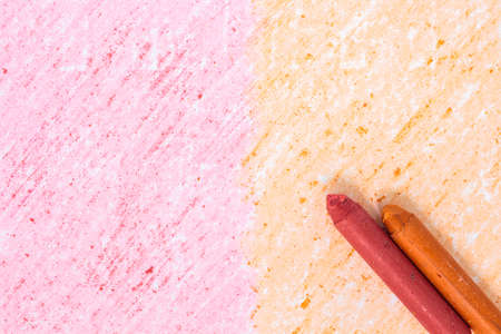 Red and orange crayon drawings on white paper background textureの写真素材