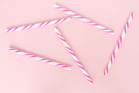 pink striped straws on pink backgroundの写真素材