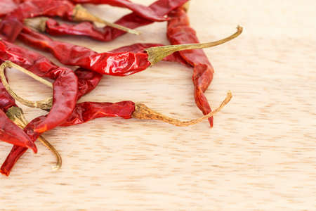 dried red chilies on wooden background.