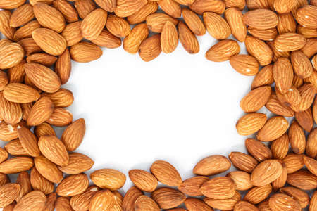 heap almonds top view frame or border on white background.の写真素材