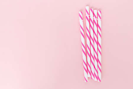 pink striped straws on pink backgroundの写真素材